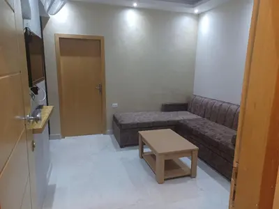 a small living room with a couch and a table at ميراج باي ريزورت منتجع لافستا in Hurghada