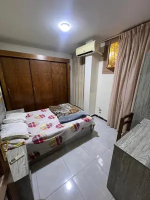 a bedroom with a bed with a wooden headboard at 3 bedroom duplex in Hurghada