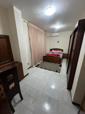 a small room with a bed and a desk at 3 bedroom duplex in Hurghada