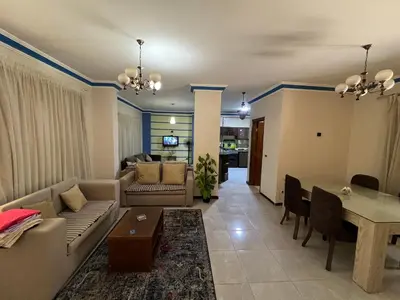 a living room with a couch and a table at 3 bedroom duplex in Hurghada