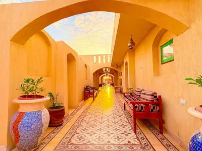 a hallway with vases and tables in a building at Nile Compound Garden in Al Aqālitah