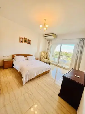 a bedroom with a bed and a large window at touristic centre Andalusia in Hurghada