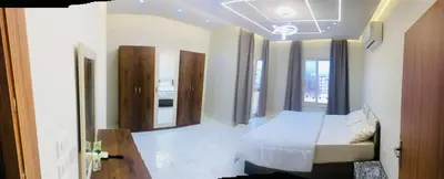 a bedroom with a bed and some windows at Hurghada Portrait in Hurghada