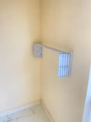 a small room with a window with blue curtains at Hurghada Portrait in Hurghada