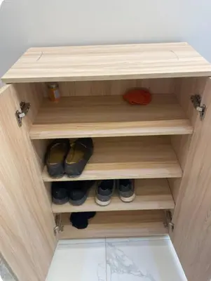 a wooden shelf with shoes in a closet at Hurghada Portrait in Hurghada