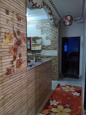 a kitchen with a wooden wall with a mirror at Hamza home in Quseir