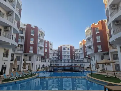 a view of an apartment complex with a swimming pool at Cozy one bedroom apartment in AquaPalms resort in Hurghada