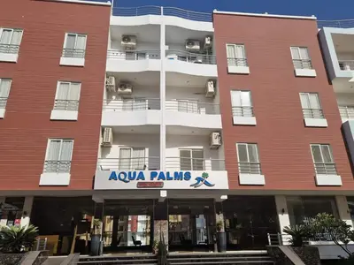 a large red building with a sign on it at Cozy one bedroom apartment in AquaPalms resort in Hurghada