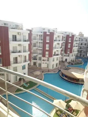 a view from a balcony of a apartment complex at Cozy one bedroom apartment in AquaPalms resort in Hurghada