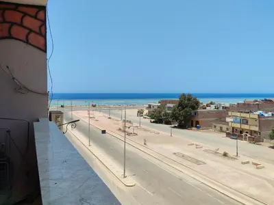 a view of a street with the ocean in the background at Sea view in Quseir