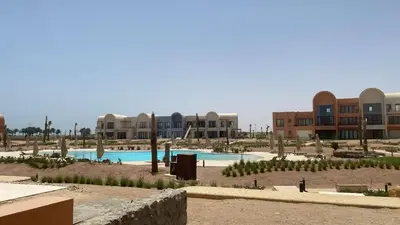 a resort with a swimming pool and some buildings at Serene 1BR Haven Kamaran in Hurghada