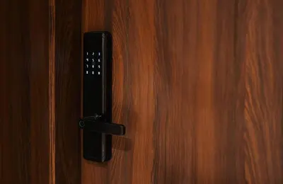 a black door handle on a wooden door at Serene 1BR Haven Kamaran in Hurghada