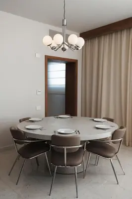 a dining room table with chairs and a chandelier at Fanadir Marina Plunge Pool & Sea View in Hurghada