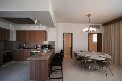 a kitchen and dining room with a table and chairs at Fanadir Marina Plunge Pool & Sea View in Hurghada