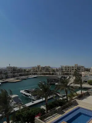 a view of a harbor with palm trees and buildings at Fanadir Marina Plunge Pool & Sea View in Hurghada