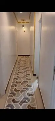 a hallway with a stone floor in a room at Poseidon Apartments in Hurghada