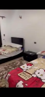 a room with a bed with a blanket with cows on it at Poseidon Apartments in Hurghada