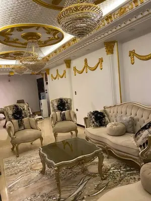 a living room with couches and a chandelier at Poseidon Apartments in Hurghada