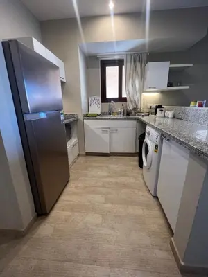 a kitchen with a stainless steel refrigerator and a dishwasher at Cozy Lagoon Escpae-1Bdr Retreat in Hurghada