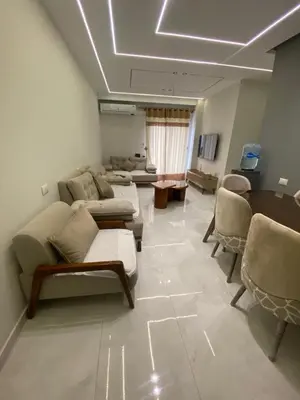 a large living room with couches and a table at Private apartment in Hurghada