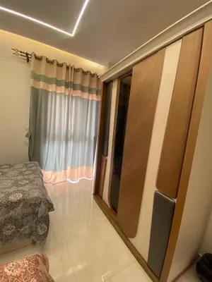 a bedroom with a sliding glass door with a bed at Private apartment in Hurghada