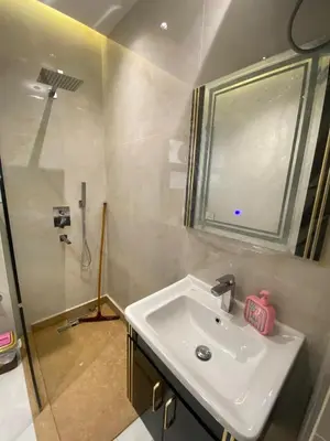 a bathroom with a sink and a mirror and a shower at Private apartment in Hurghada