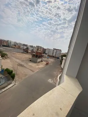 a view of an empty street from a window at Private apartment in Hurghada