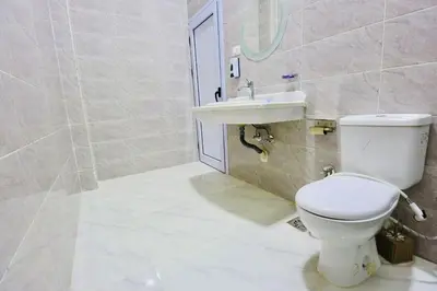 a bathroom with a toilet and a sink at Memnon House in Al Karnak
