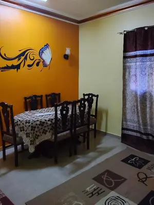 a room with a table and a butterfly on the wall at Hamza house in Quseir