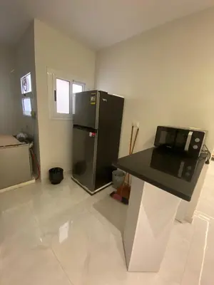 a kitchen with a black refrigerator and a counter at Private apartment in Hurghada