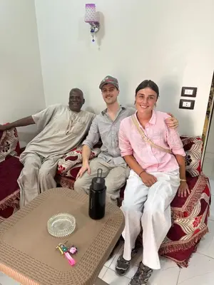 a group of three people sitting on a couch at Habob Nubian Guest House in Aswan