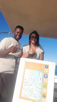 a man and a woman standing next to a sign at Habob Nubian Guest House in Aswan