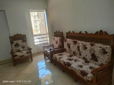 a living room with two chairs and a couch at مدينة ناصر غرب أسيوط