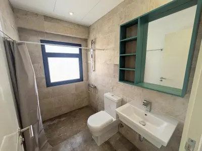 a bathroom with a toilet and a sink and a mirror at Modern 2BR Somabay Seaview Villa Free Beach & Pool in Hurghada