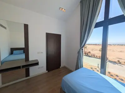 a bedroom with a bed and a large window at Modern 2BR Somabay Seaview Villa Free Beach & Pool in Hurghada