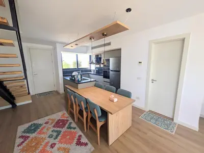 a kitchen and dining room with a wooden table and chairs at Modern 2BR Somabay Seaview Villa Free Beach & Pool in Hurghada