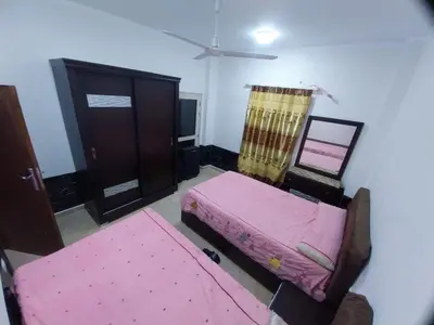 a room with two beds and a dresser at فيلا مبارك الغردقه البحر الاحمر in Hurghada