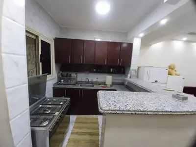 a kitchen with a stove and a counter top at فيلا مبارك الغردقه البحر الاحمر in Hurghada