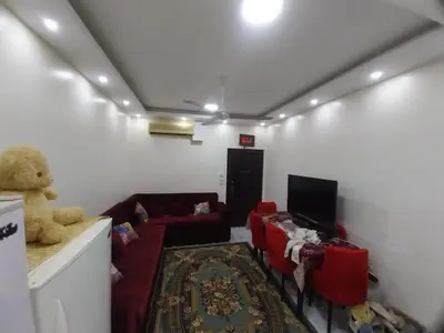 a living room with a teddy bear and a couch at فيلا مبارك الغردقه البحر الاحمر in Hurghada