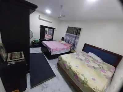 a bedroom with two beds and a mirror at فيلا مبارك الغردقه البحر الاحمر in Hurghada