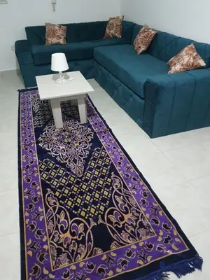 a blue couch and a table in a living room at Oasis compound in Hurghada