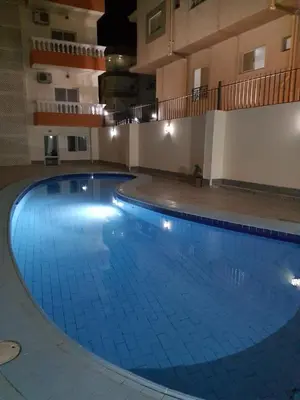 a large swimming pool in a large building at Oasis compound in Hurghada