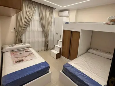 a bedroom with two bunk beds and a window at Helal Apartment in Hurghada