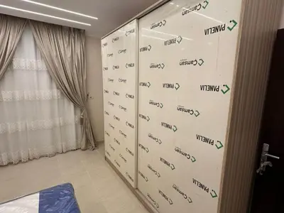 a bedroom with a door with writing on it at Helal Apartment in Hurghada