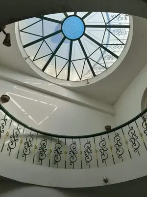a ceiling with a window and a spiral staircase at Nube's dream house in Luxor