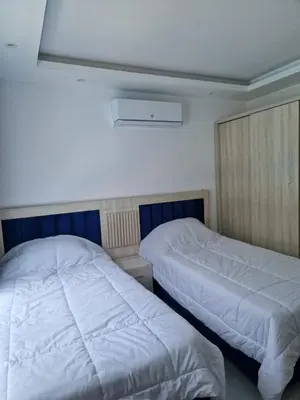 two beds in a room with white walls at Hurghada Fanader Bay Lever111 in Hurghada