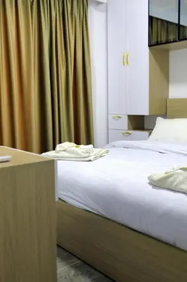 a bedroom with a large bed with a desk and a bedskirts at One bedroom apartment with living room in Aqua Infinity before El Gouna in Hurghada