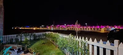 a bridge with pink lights in the distance at night at فيلا بجوار سينزو مول in Hurghada