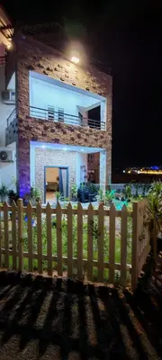 a white picket fence in front of a house at فيلا بجوار سينزو مول in Hurghada