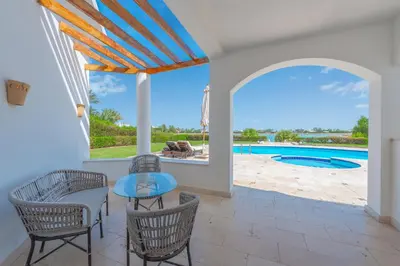 a patio with a table and chairs and a pool at Beautiful 4 BDR Villa With Private Pool in Hurghada